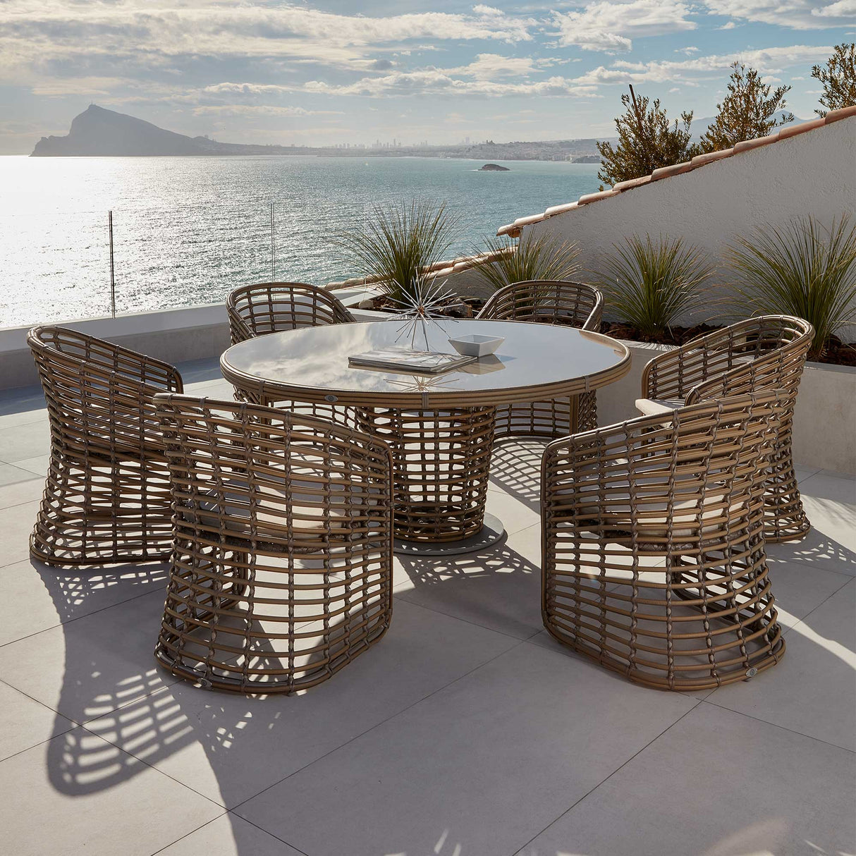 Ruby Outdoor 7-Piece Dining Set with Round Table and Sunbrella Cushions Model 23672-KMNP-7PC-CUSH by Skyline Design